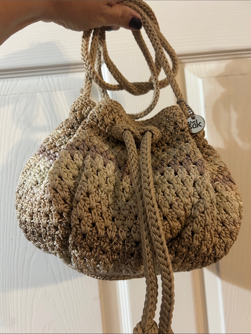 The Sak Crochet Drawstring Bucker Bag in Taupe/Brown